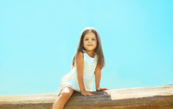 Pretty little girl outdoors, blue sky, summer day - Fotografie, Obrázek