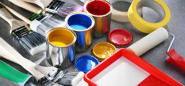 Paint cans and paintbrushes of different size  for home decorating purposes. - Photo, Image