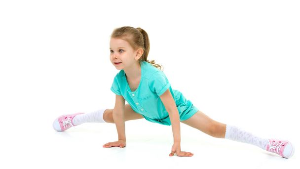 Adorable active little girl doing split on floor - Fotoğraf, Görsel