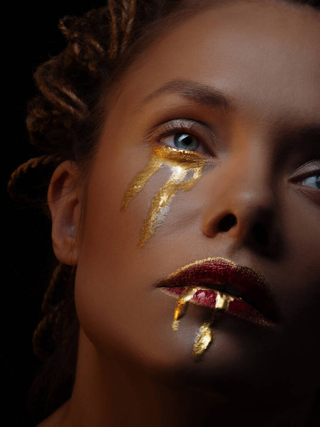 Mysterious mystical heroine with golden drops on her face, - Φωτογραφία, εικόνα