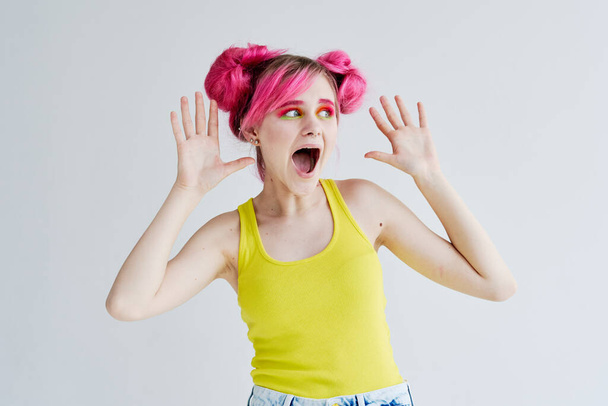 proportional woman with pink hair in a yellow tank top lifestyle - Fotó, kép