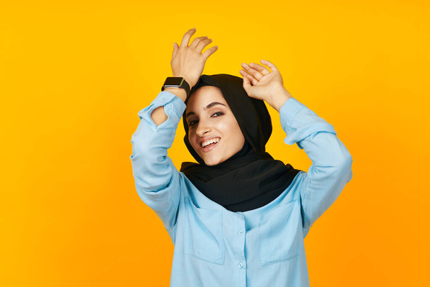 woman in black hijab electronic clock entertainment technology isolated background - Valokuva, kuva