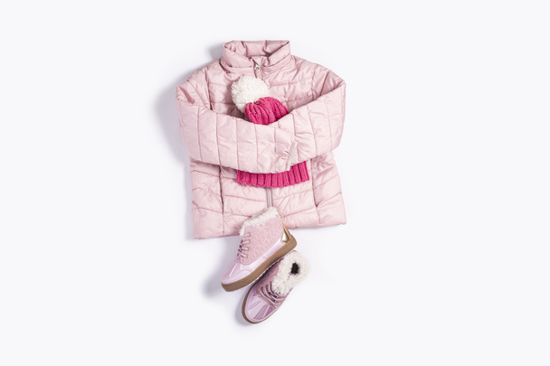 Kids jacket, hat and boots for a girl on a white background. Top view, flat lay - Photo, Image