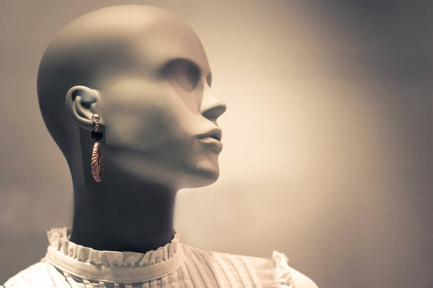 Portrait of mannequin. Woman profile face in store window. Isolated bald dummy. Shopping, beauty or feminine concept. Copy space for text - Zdjęcie, obraz