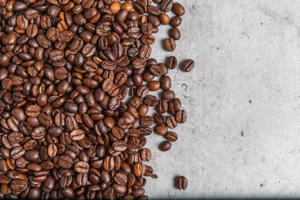 Background with roasted coffee beans on concrete background, coffee concept, space for text. - Photo, Image