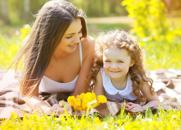 Happy mom and daughter having fun in summer day - Photo, image