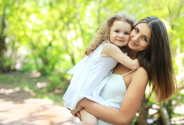 Lovely mom and daughter in warm sunny summer day, happy family - Photo, Image