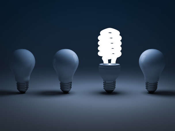 Эко-энергосберегающая лампочка, одна светящаяся компактная люминесцентная лампочка, стоящая среди неосвещенных ламп накаливания
 - Фото, изображение