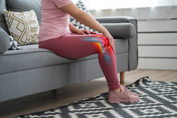 Knee pain, woman suffering from osteoarthritis at home, chiropractic treatments concept - Valokuva, kuva