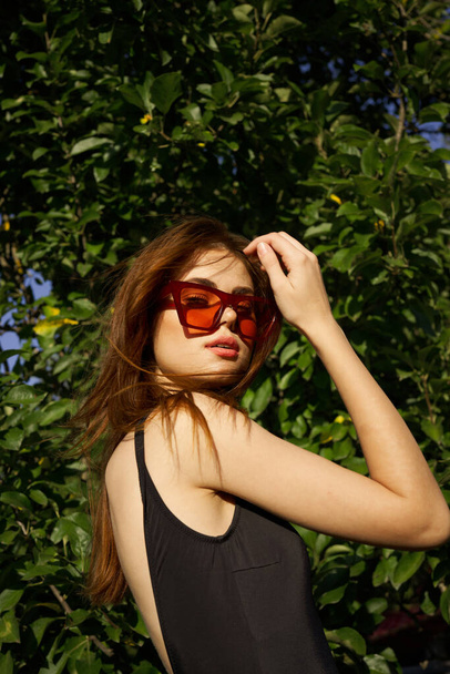pretty woman wearing sunglasses green leaves summer model - Photo, image