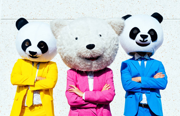 Storytelling image of a couple wearing giant panda head and colored suits. Man and woman making party in a parking lot. - 写真・画像
