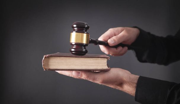 Lawyer or judge holding gavel and book. - Фото, изображение