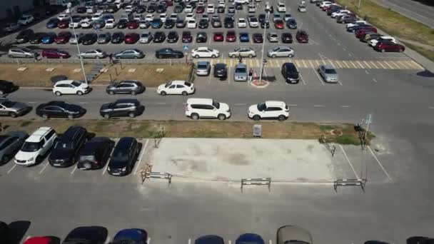 the drone moves over a parking lot with many parked cars - Footage, Video