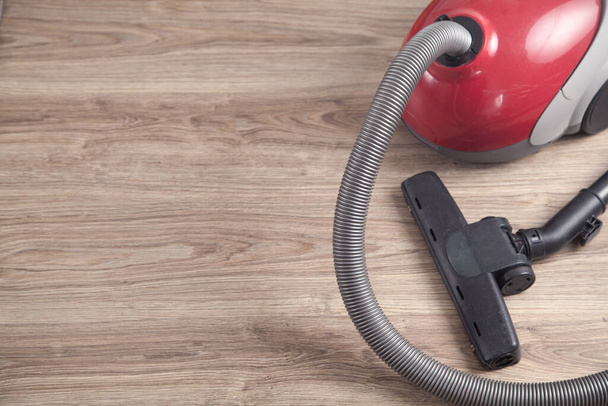 Vacuum cleaner on the wooden background. - Foto, immagini