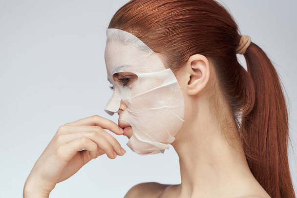 woman in cosmetic mask facial skin care rejuvenation - 写真・画像