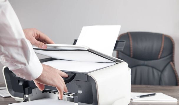 Man copying and scanning documents in office. - Fotoğraf, Görsel