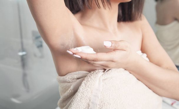 Woman applying shaving cream on armpit. Hair removal concept - Φωτογραφία, εικόνα