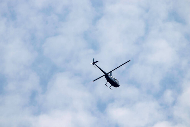 helicopter in blue summer sky by day, air transport - Φωτογραφία, εικόνα