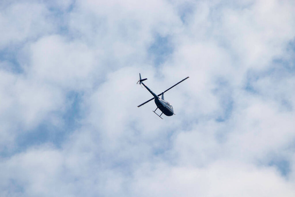 helicopter in blue summer sky by day, air transport - Foto, Imagen