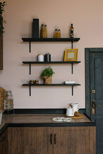 The kitchen is in the Scandinavian style. Wooden shelves with decor - Zdjęcie, obraz