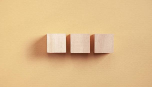 Wooden cubes on yellow background. - Foto, Imagen