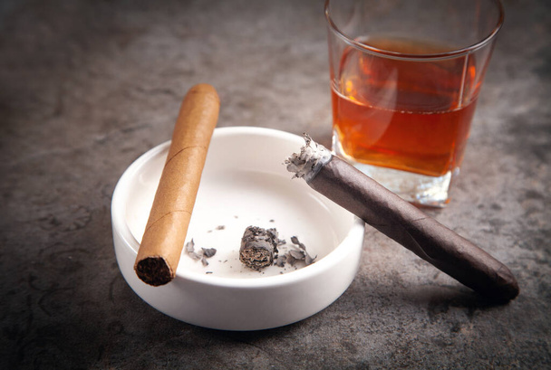 Glass of whisky, ashtray and cigars on the table. - Photo, Image