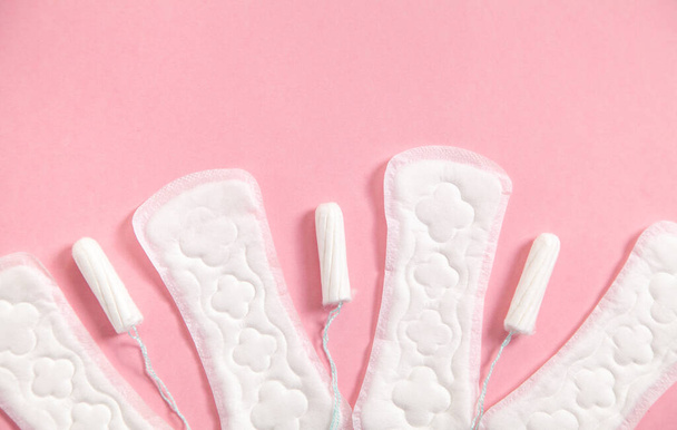 Menstrual pad and tampons on a pink background. - Фото, изображение