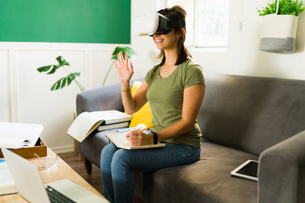 College student with VR glasses smiling and feeling happy during a university virtual reality class  - Foto, Imagen