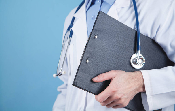 Caucasian medical doctor holding clipboard. - Photo, Image