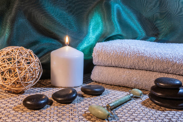 Spa, zen bazaltowe kamienie, ręczniki, świece w pokoju masażu. - Zdjęcie, obraz