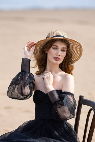 Happy young girl in a straw hat and in a black dress on the bank of the river. Thunder Sky  - Foto, Imagem