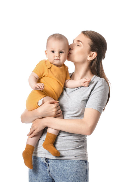 Young mother kissing little baby on white background - Foto, Imagem