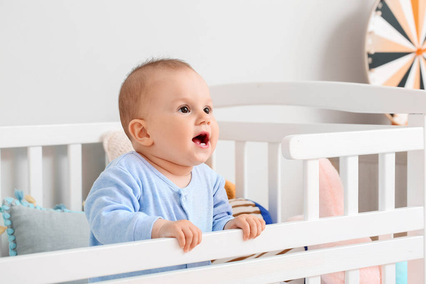 Cute little baby boy in crib - Foto, immagini