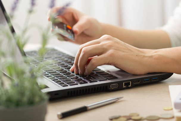 Hands holding credit card and using laptop. Online shopping. - Φωτογραφία, εικόνα