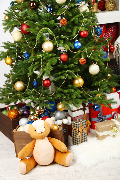 Lots of Christmas gifts on floor in festive interior - Foto, imagen