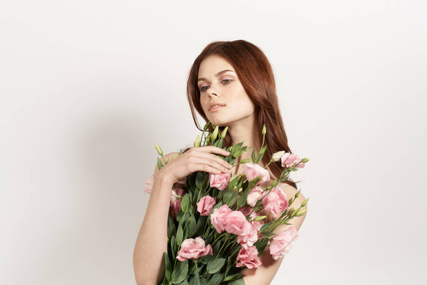 cheerful woman in dress posing flowers makeup isolated background - Zdjęcie, obraz