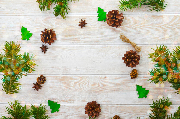 xmas background with festive natural zero waste decoration, fir branch sprigs with pine cones top view flat lay, merry christmas background with copy space text - Фото, зображення