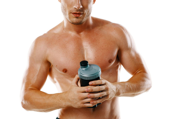 athletic man with pumped up muscular body sports drink light background - Zdjęcie, obraz