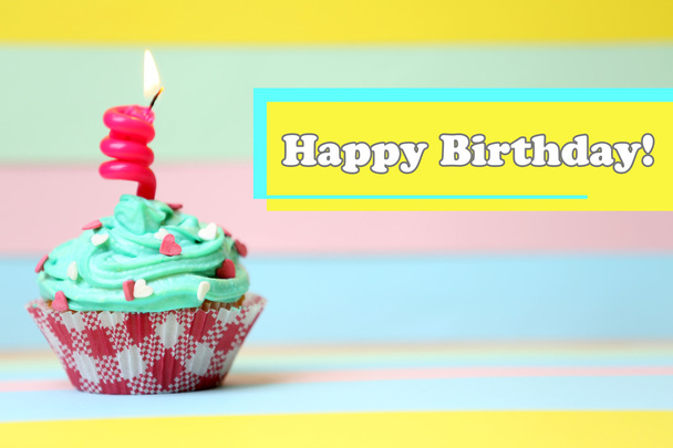 Delicious birthday cupcake on table on bright background - Foto, Imagen