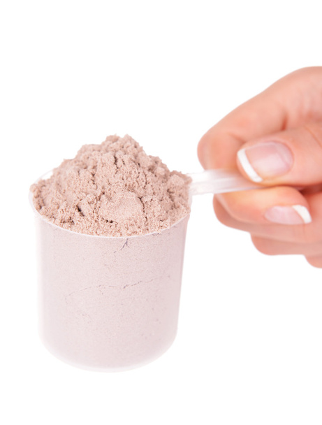 Female hand holding scoop with whey protein powder isolated on white - Foto, Bild