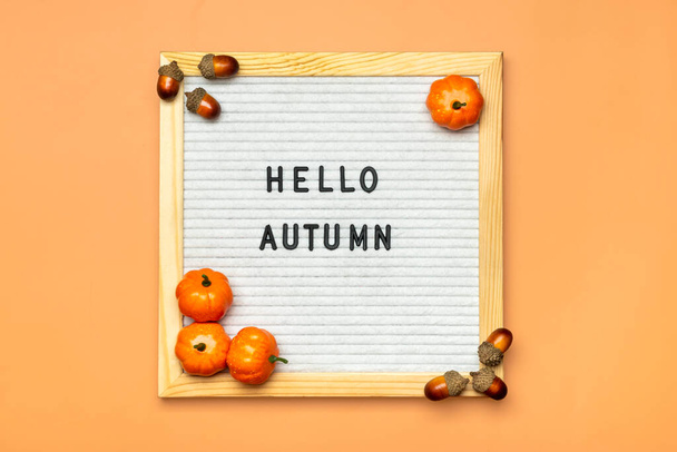 Felt boar with text Hello autumn, pumpkin on orange color background Top view Flat lay Seasonal concept Hello September, October, November. - Photo, Image