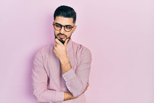 Handsome man with beard wearing casual shirt and glasses thinking looking tired and bored with depression problems with crossed arms.  - Foto, Imagem