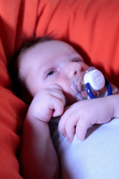 newborn baby sleeps on pillow with pacifier. High quality photo - Zdjęcie, obraz