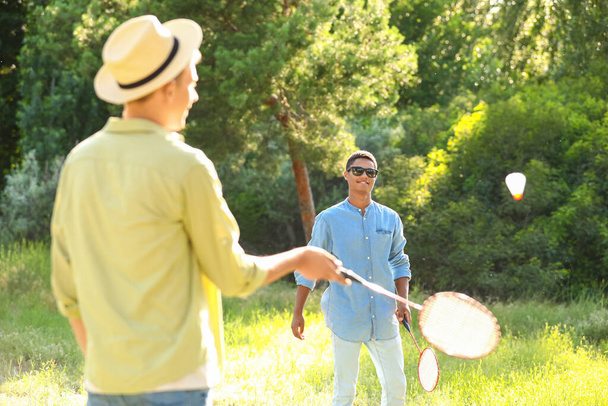 Young men playing badminton  outdoors - Valokuva, kuva