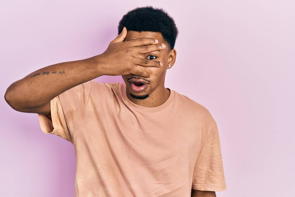 Young african american man wearing casual t shirt with angry face, negative sign showing dislike with thumbs down, rejection concept  - Photo, image