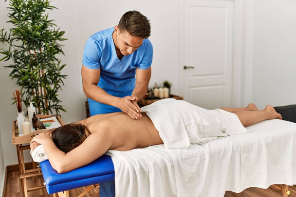 Physiotherapist making massage to woman at beauty center. - 写真・画像