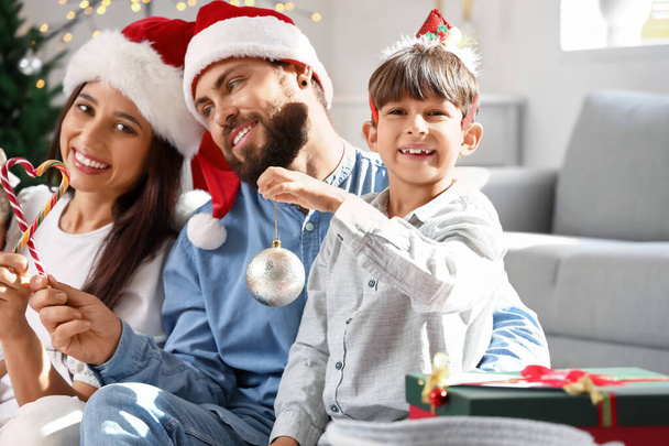 Cute little boy celebrating Christmas with his parents at home - Photo, Image