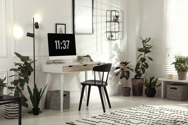 Stylish room interior with comfortable workplace. Home office - Foto, imagen