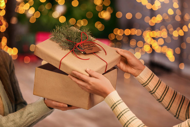 Γυναίκες άνοιγμα κουτί δώρου στο σπίτι την παραμονή των Χριστουγέννων, closeup - Φωτογραφία, εικόνα