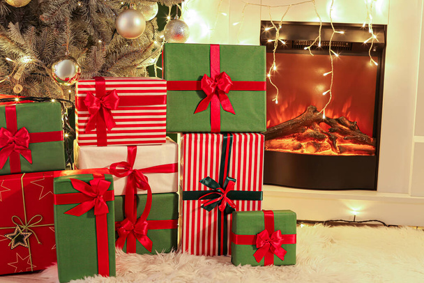 Beaucoup de boîtes cadeaux de Noël près de la cheminée dans le salon - Photo, image